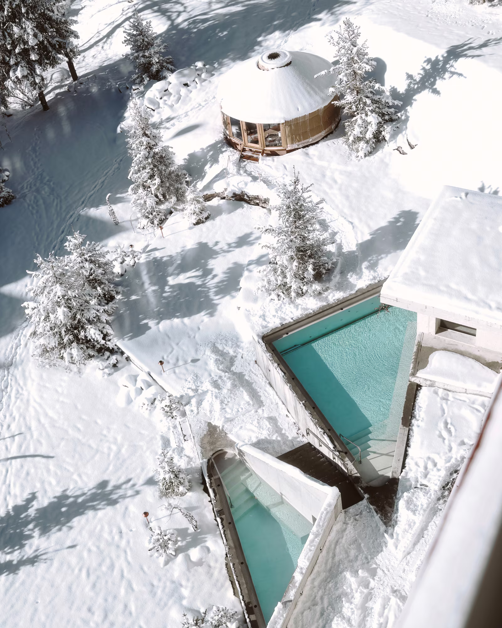 An aerial winter view of Grand Hotel Belvedere's outdoor pool and spa pavilion.