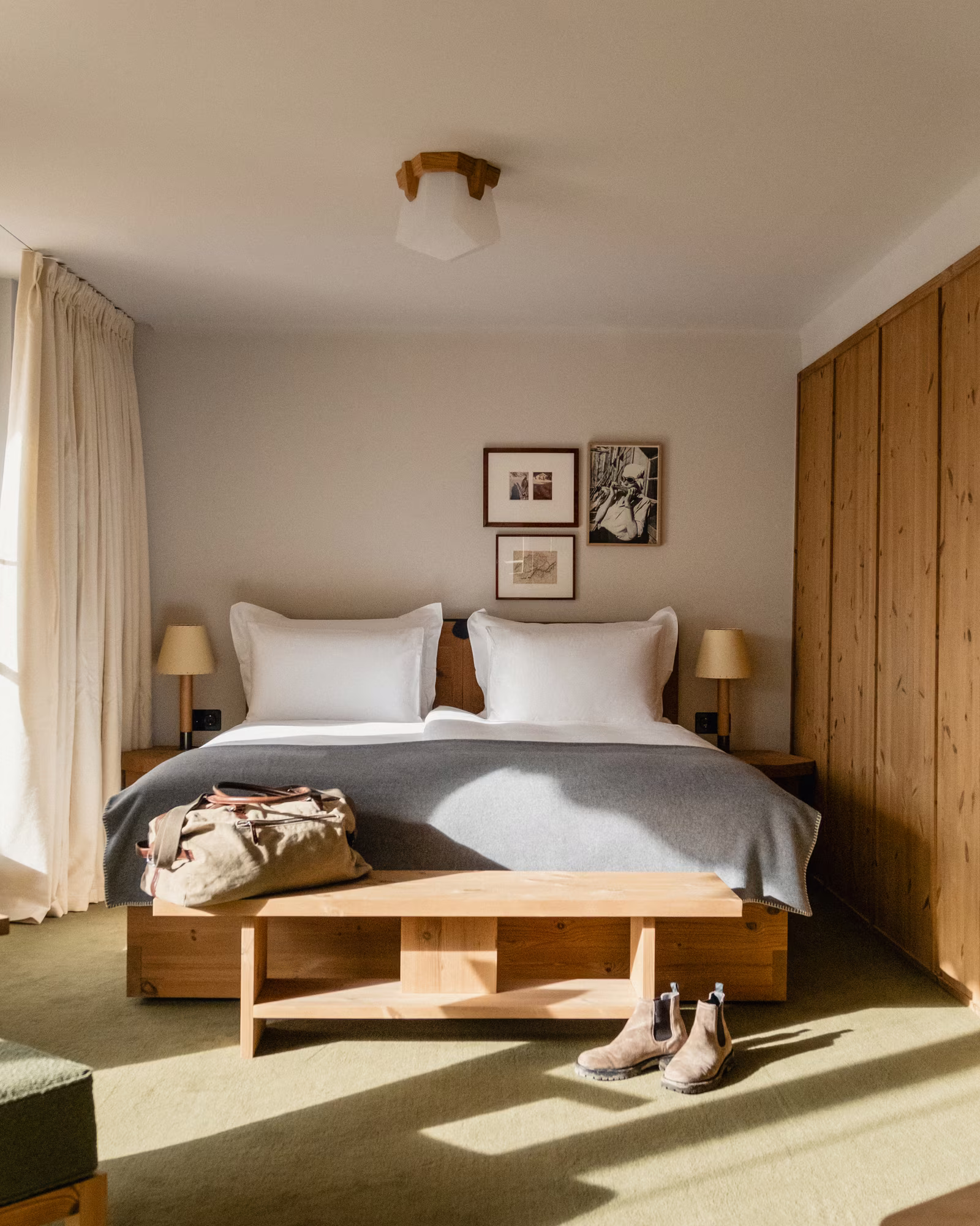 A sunlit guest room at Grand Hotel Belvedere with timber joinery and mountain-inspired furnishings.