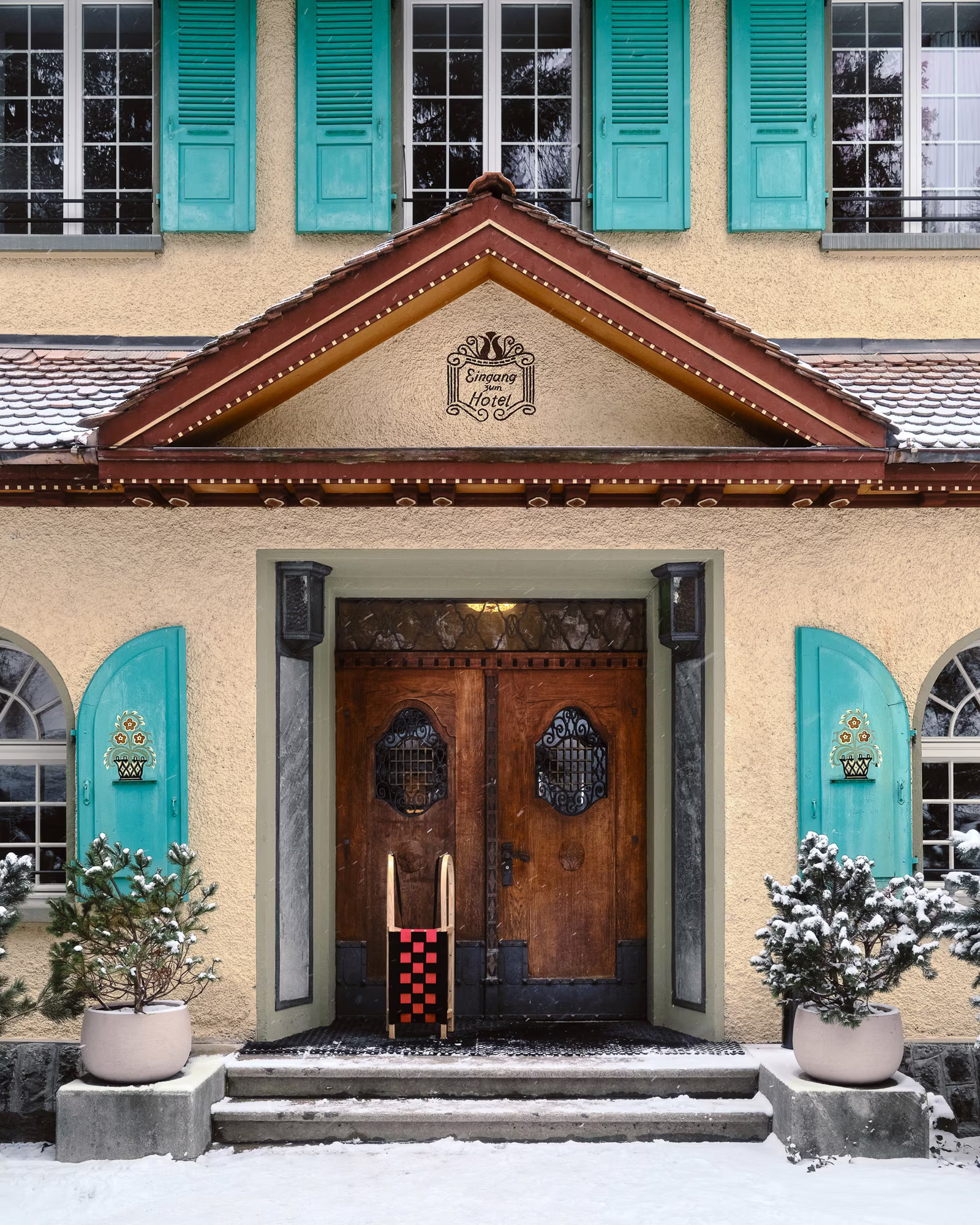 The historic entrance of Grand Hotel Belvedere framed by snow.