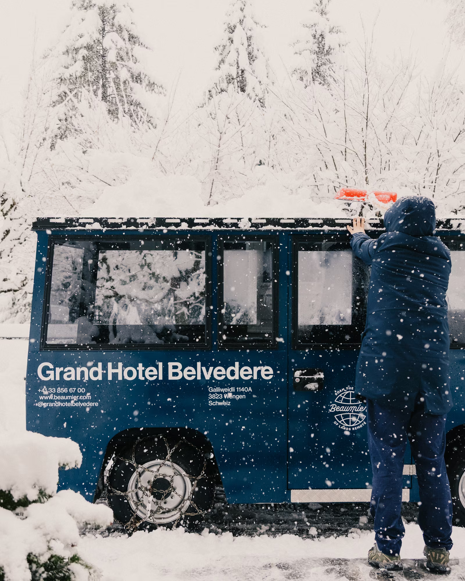 Grand Hotel Belvedere's electric shuttle being prepared during snowfall.