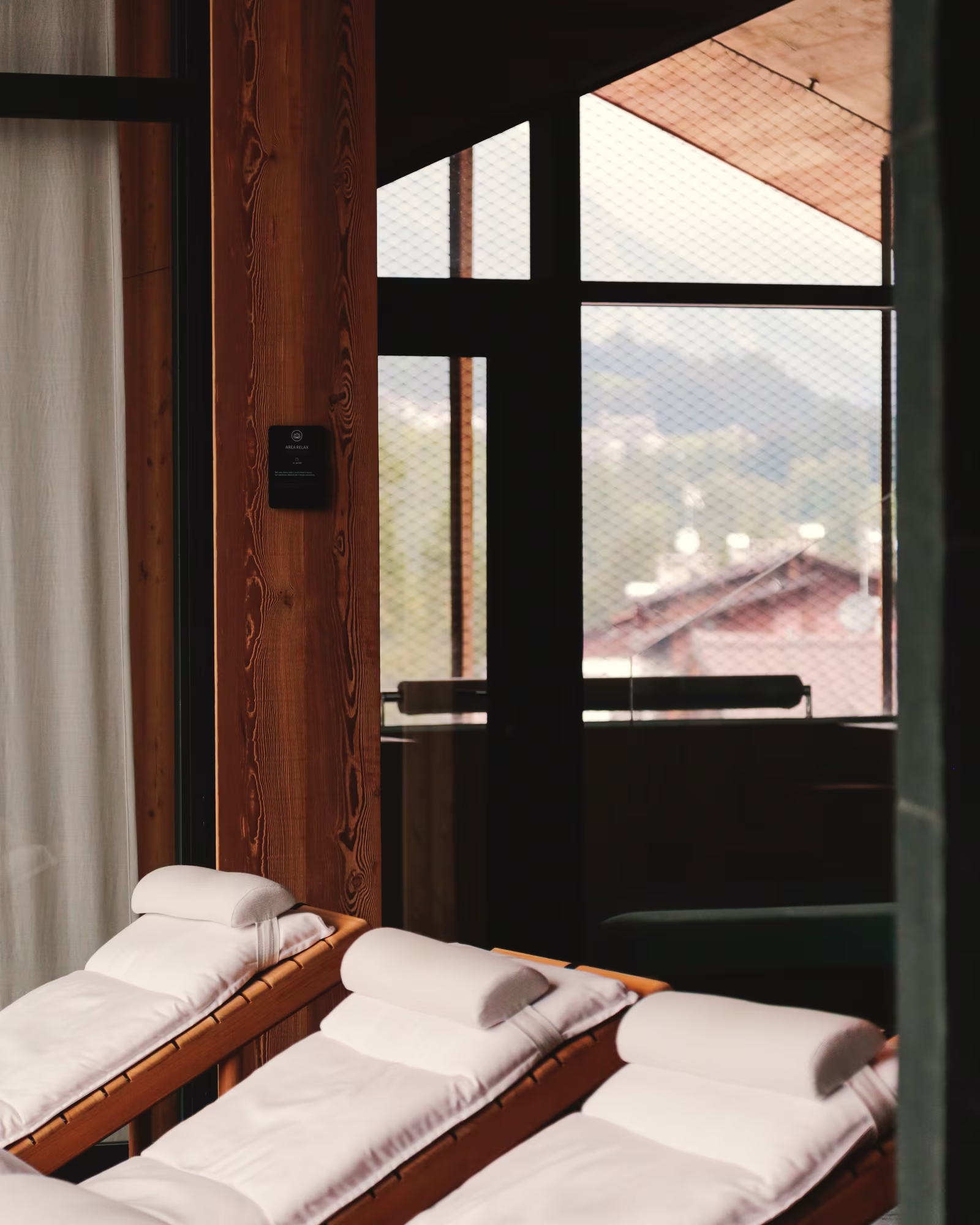 Spa loungers beside tall windows overlooking Cortina.