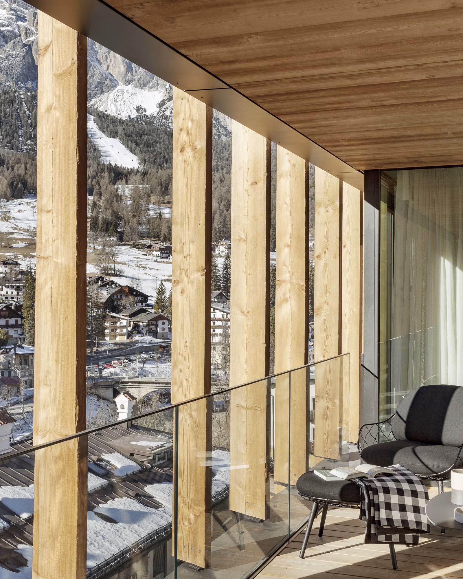 Hotel terrace seating overlooking snowy Cortina and the mountains.
