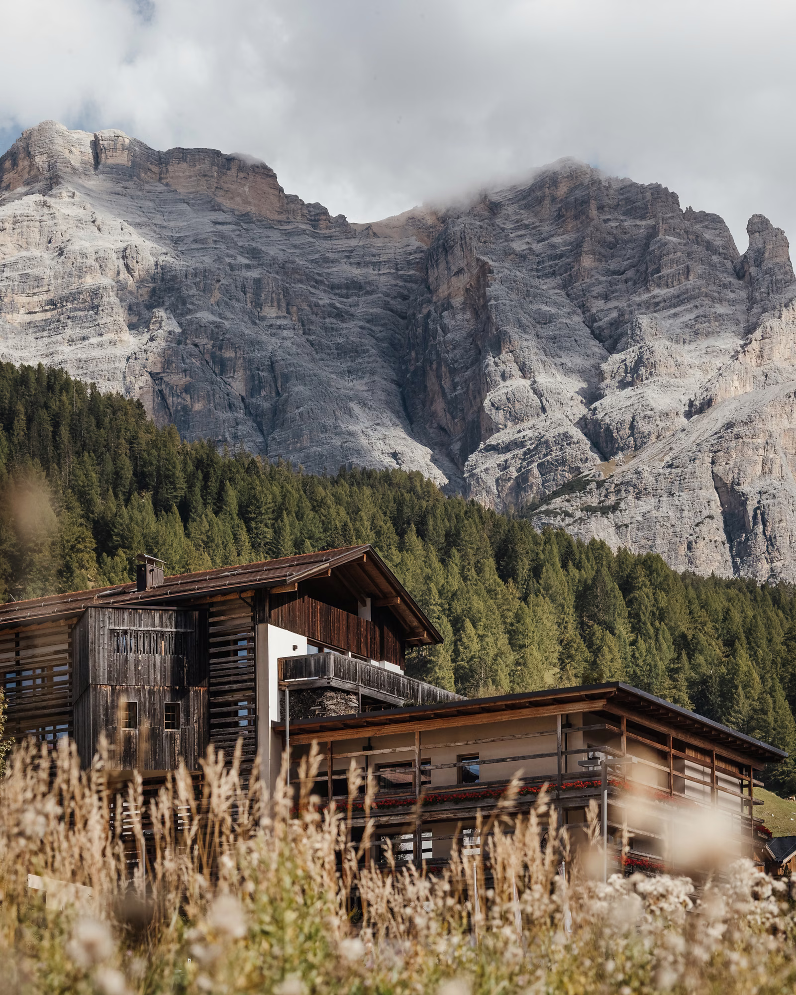Lagació beneath rocky Dolomite peaks in autumn