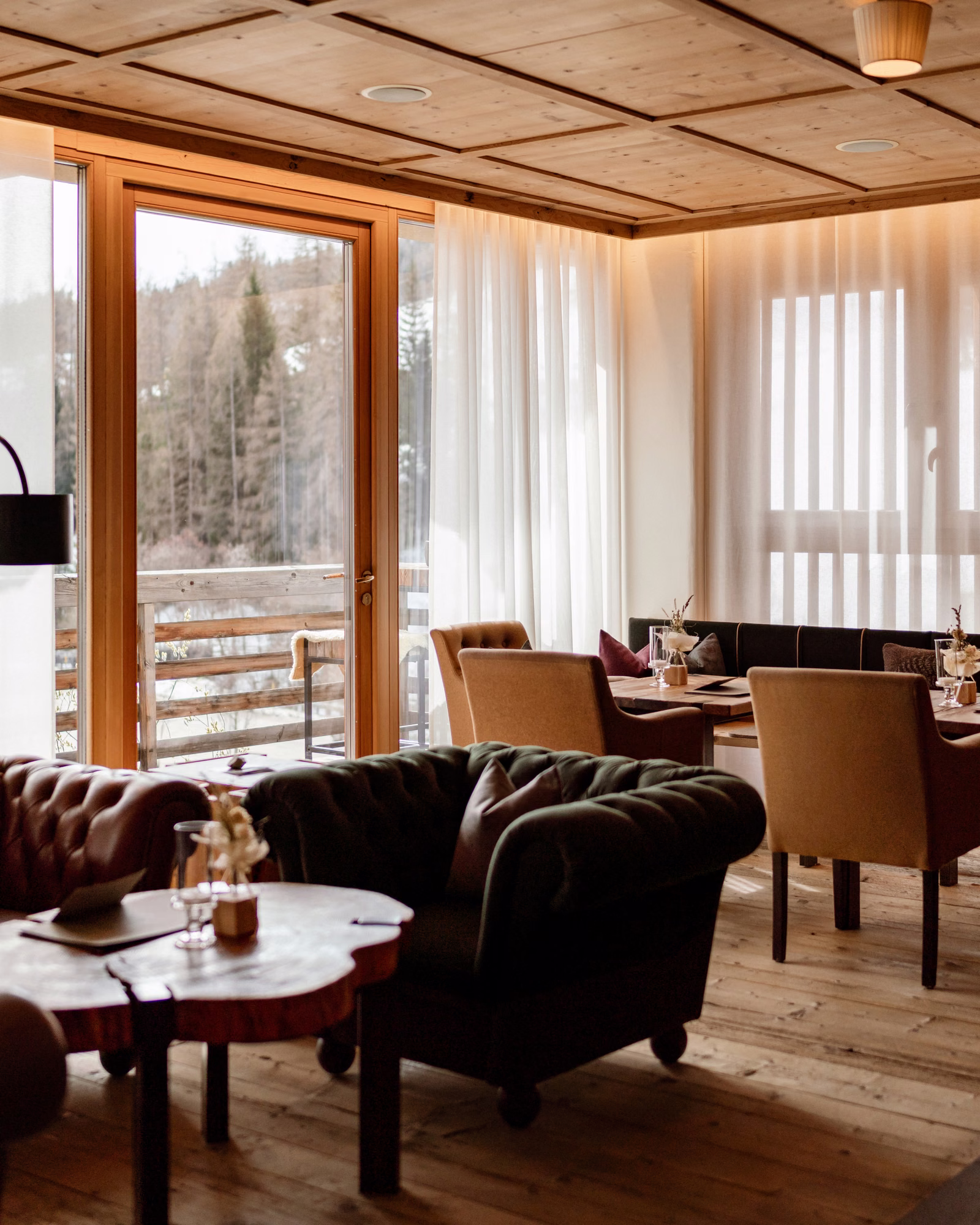 Wood-panelled Lagació lounge with mountain-facing windows