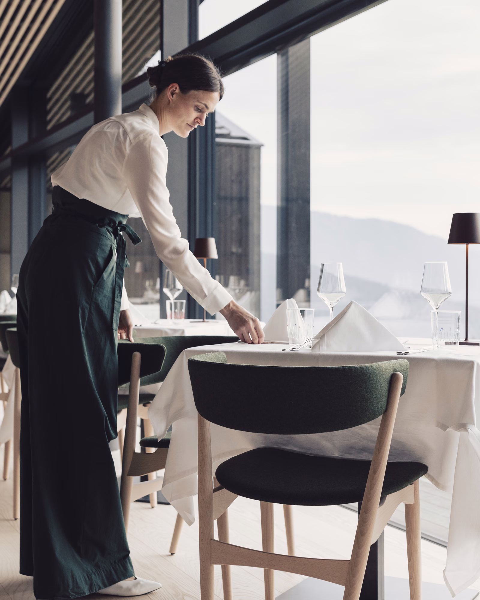 The mountain-facing dining room being prepared for service at Milla Montis