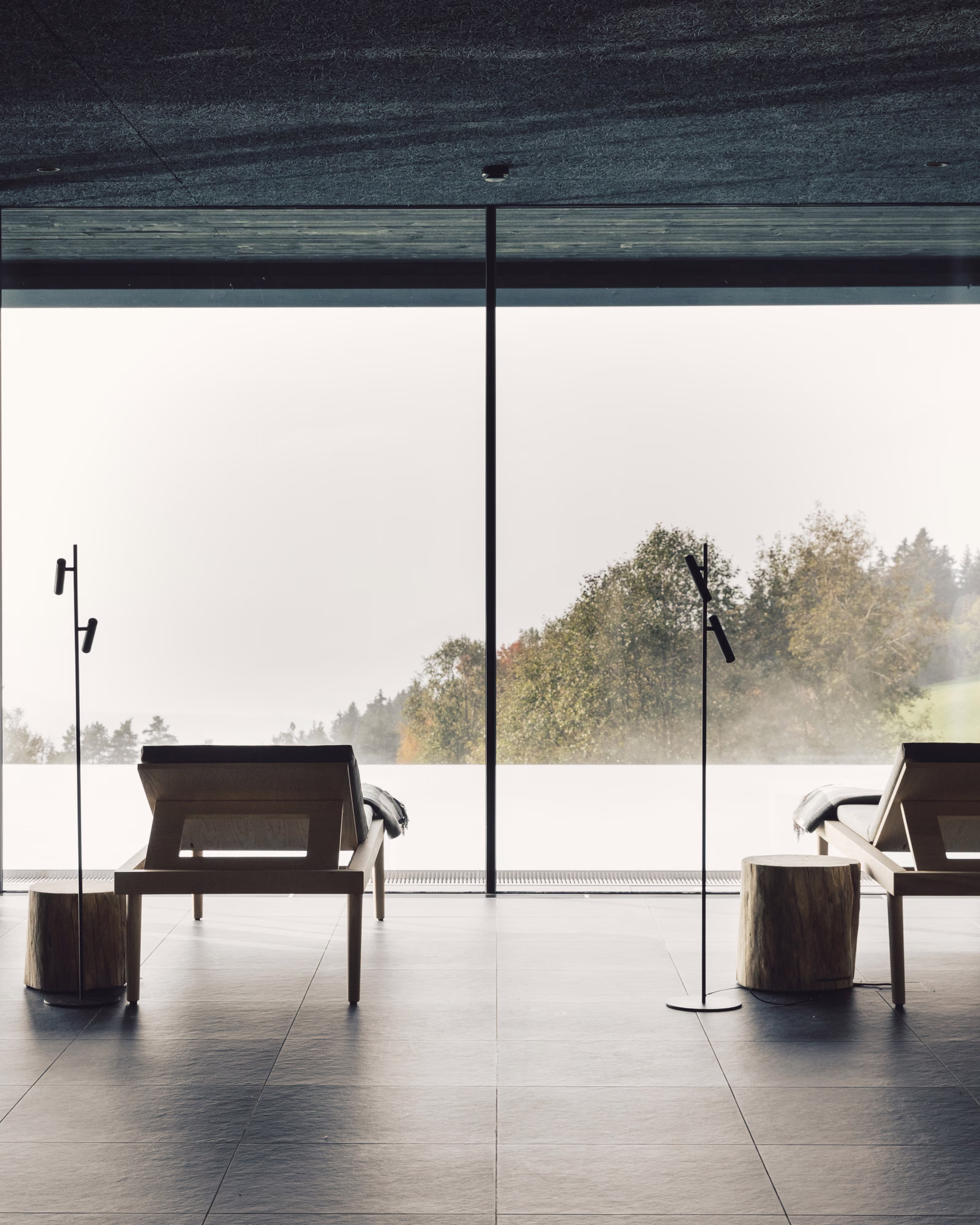 Quiet spa loungers facing the landscape through full-height windows at Milla Montis