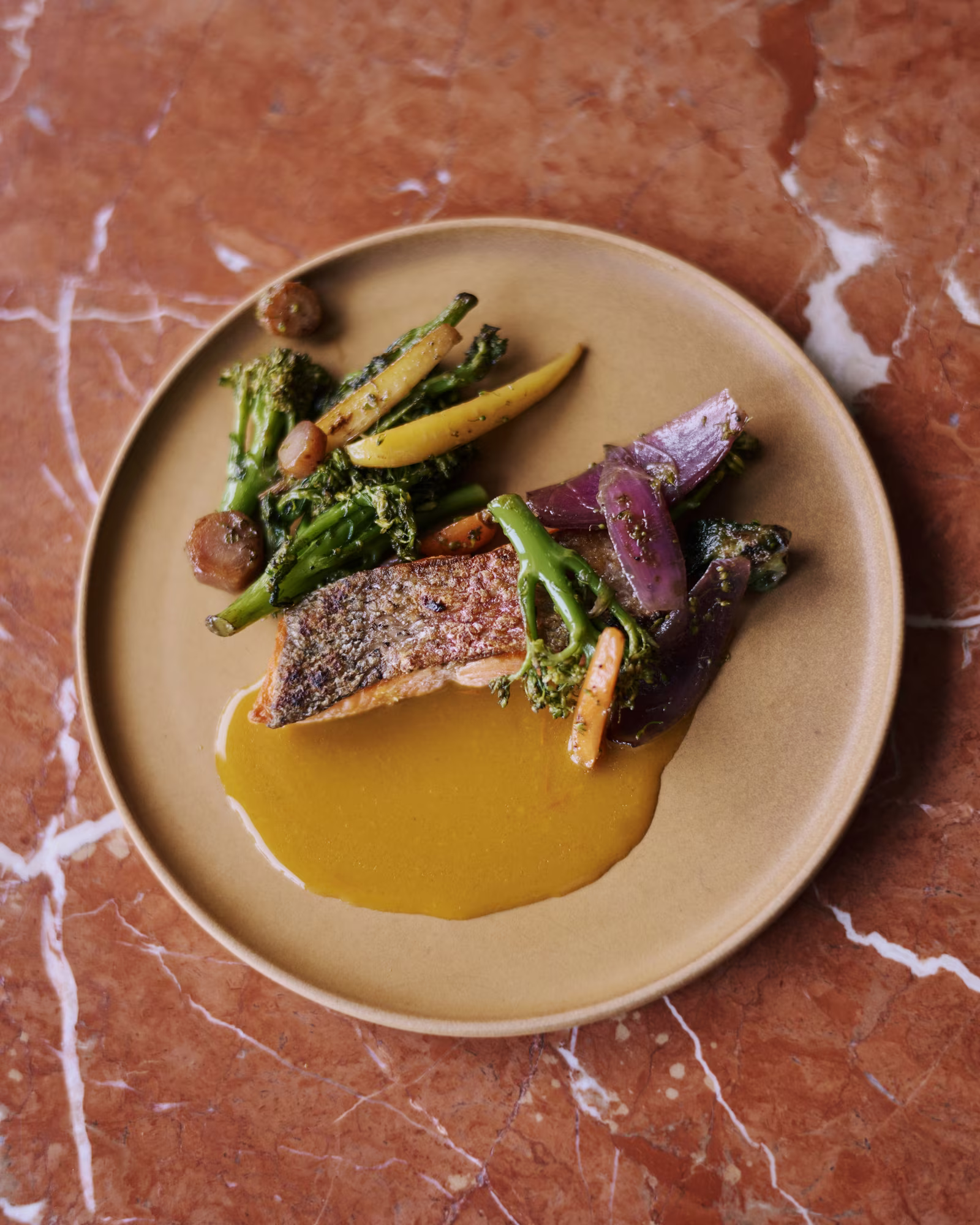 A plated dish of fish and seasonal vegetables at The Brecon.