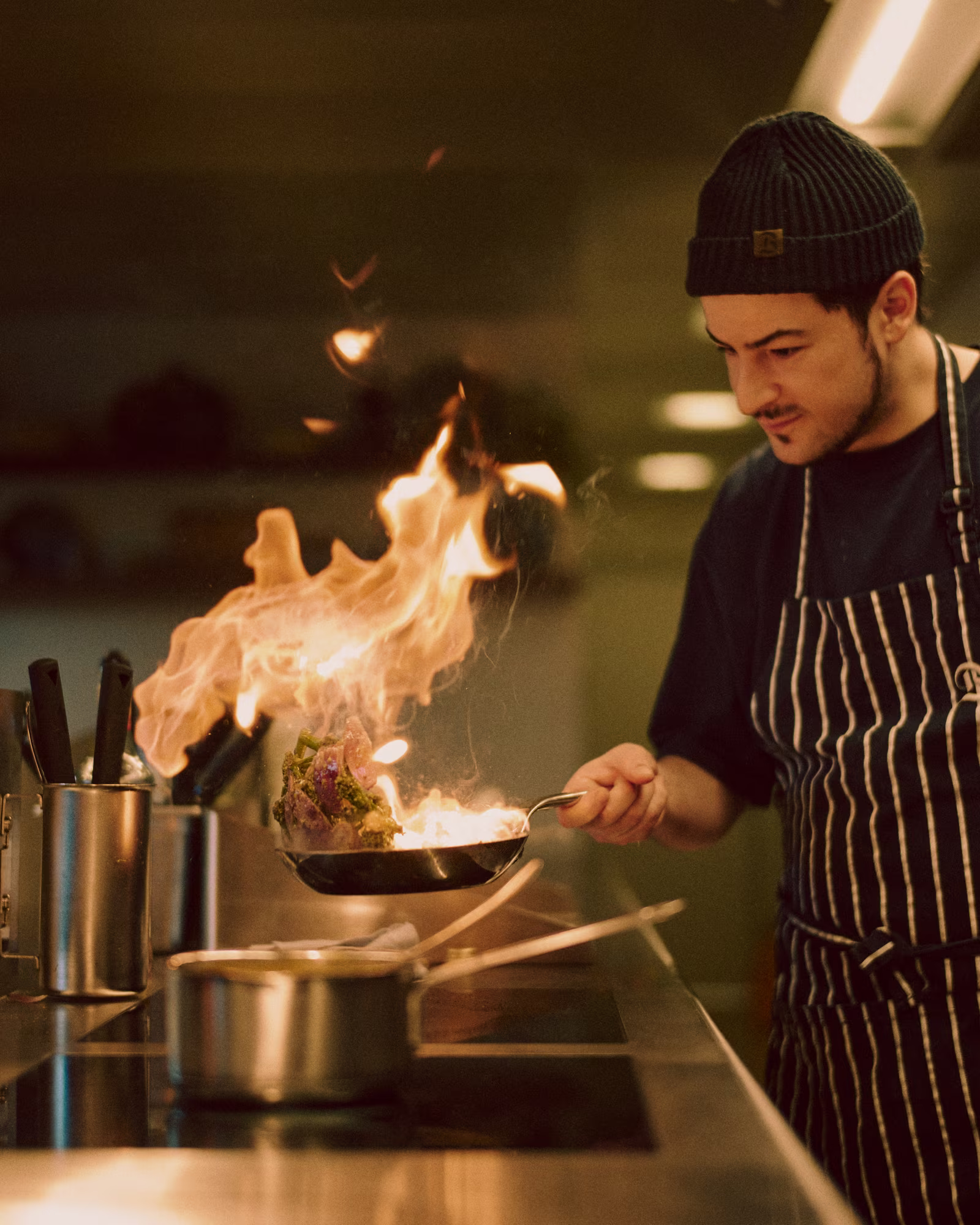 A chef flambéing a pan in The Brecon kitchen.