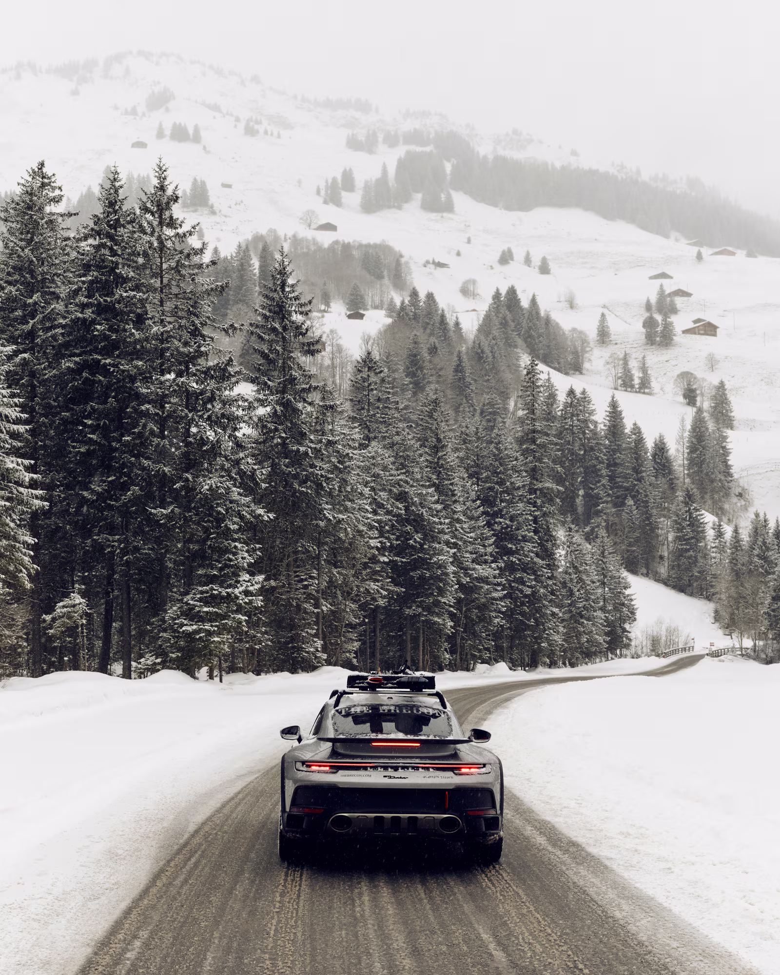 A car carrying skis on a snow-covered road near Adelboden.