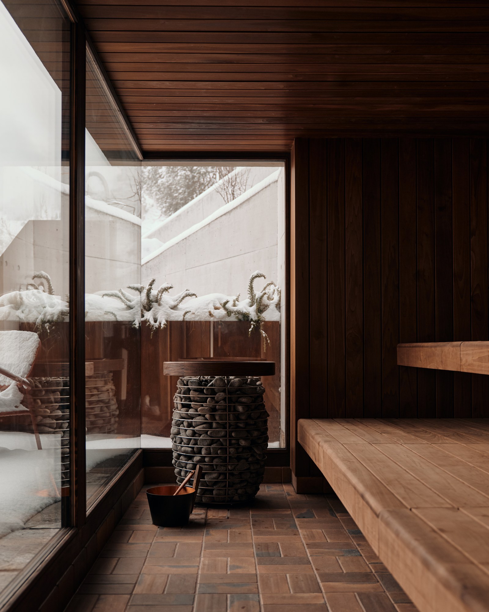 The Brecon's sauna looking onto a snowy outdoor terrace.