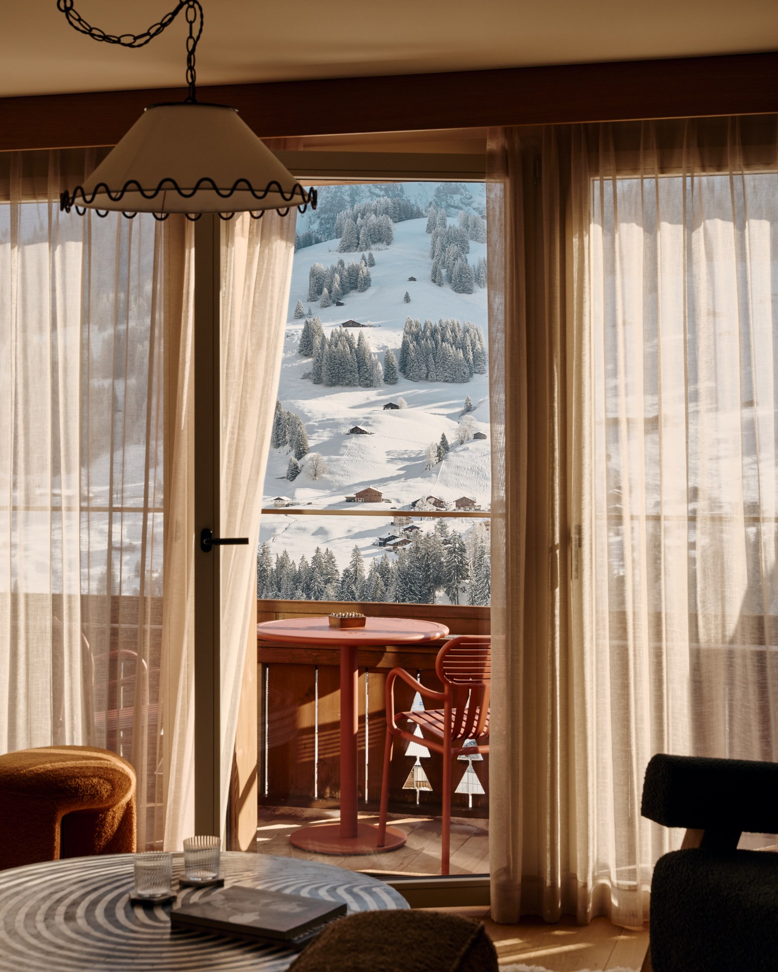 The Brecon lounge opening onto a snowy mountain balcony.